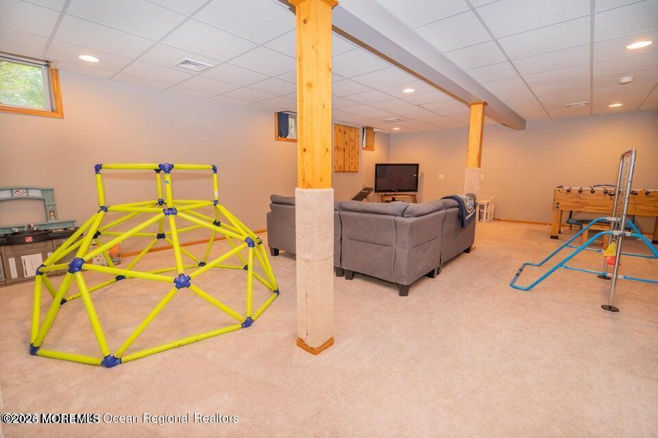 1 Kari Court Jackson, NJ 08527 - Photo 31 of 66 a living room with a gym equipment and a chandelier