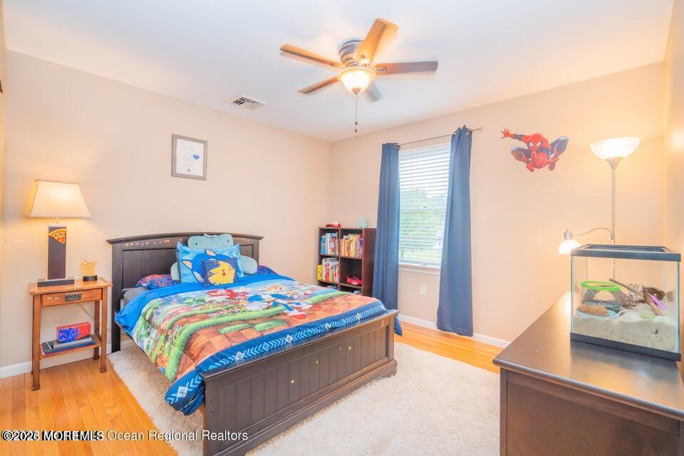 1 Kari Court Jackson, NJ 08527 - Photo 39 of 66 a bedroom with a bed and a chandelier