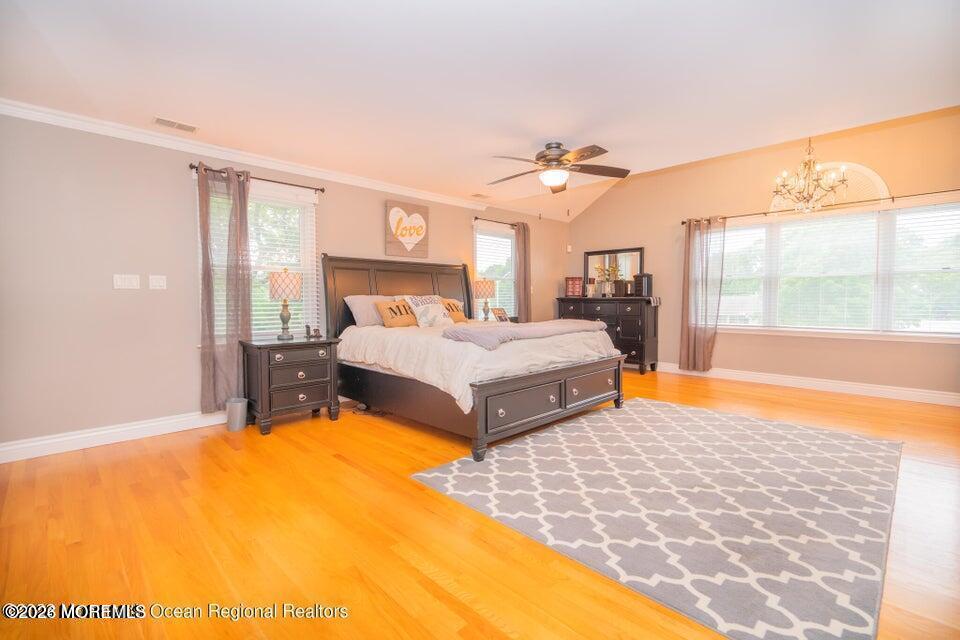 1 Kari Court Jackson, NJ 08527 - Photo 43 of 66 a bedroom with a large bed and a chandelier