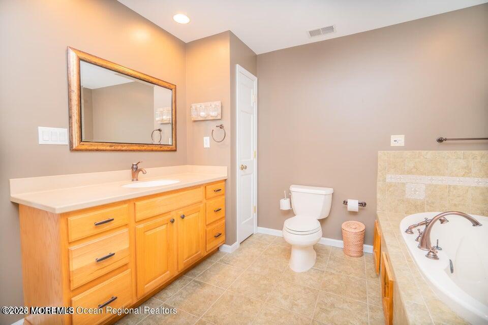 1 Kari Court Jackson, NJ 08527 - Photo 50 of 66 a bathroom with a sink a toilet and a mirror