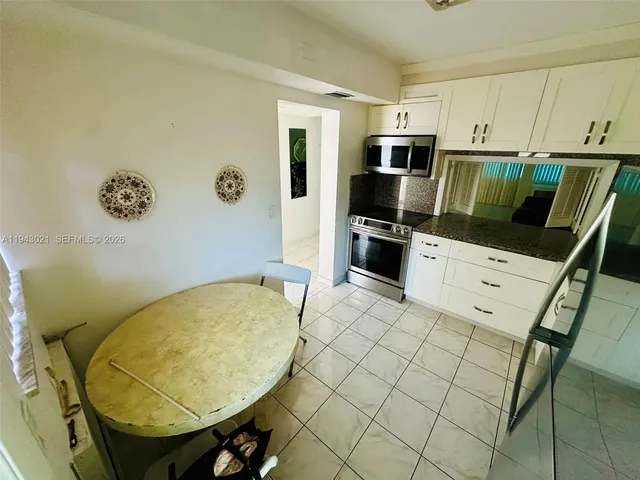 a kitchen with stainless steel appliances a stove a microwave a sink and cabinets