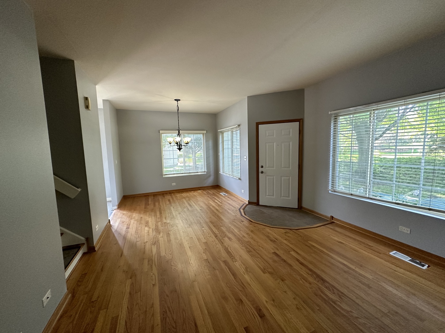 130 Creston Circle Aurora, IL 60504 - Photo 3 of 11 an empty room with wooden floor and windows