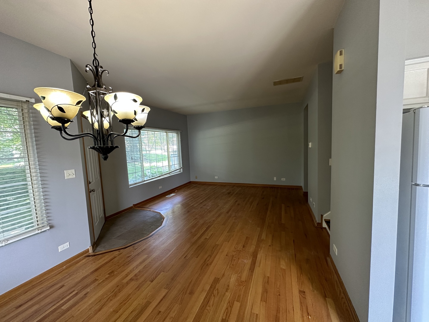 130 Creston Circle Aurora, IL 60504 - Photo 7 of 11 a dining room with wooden floor chandelier