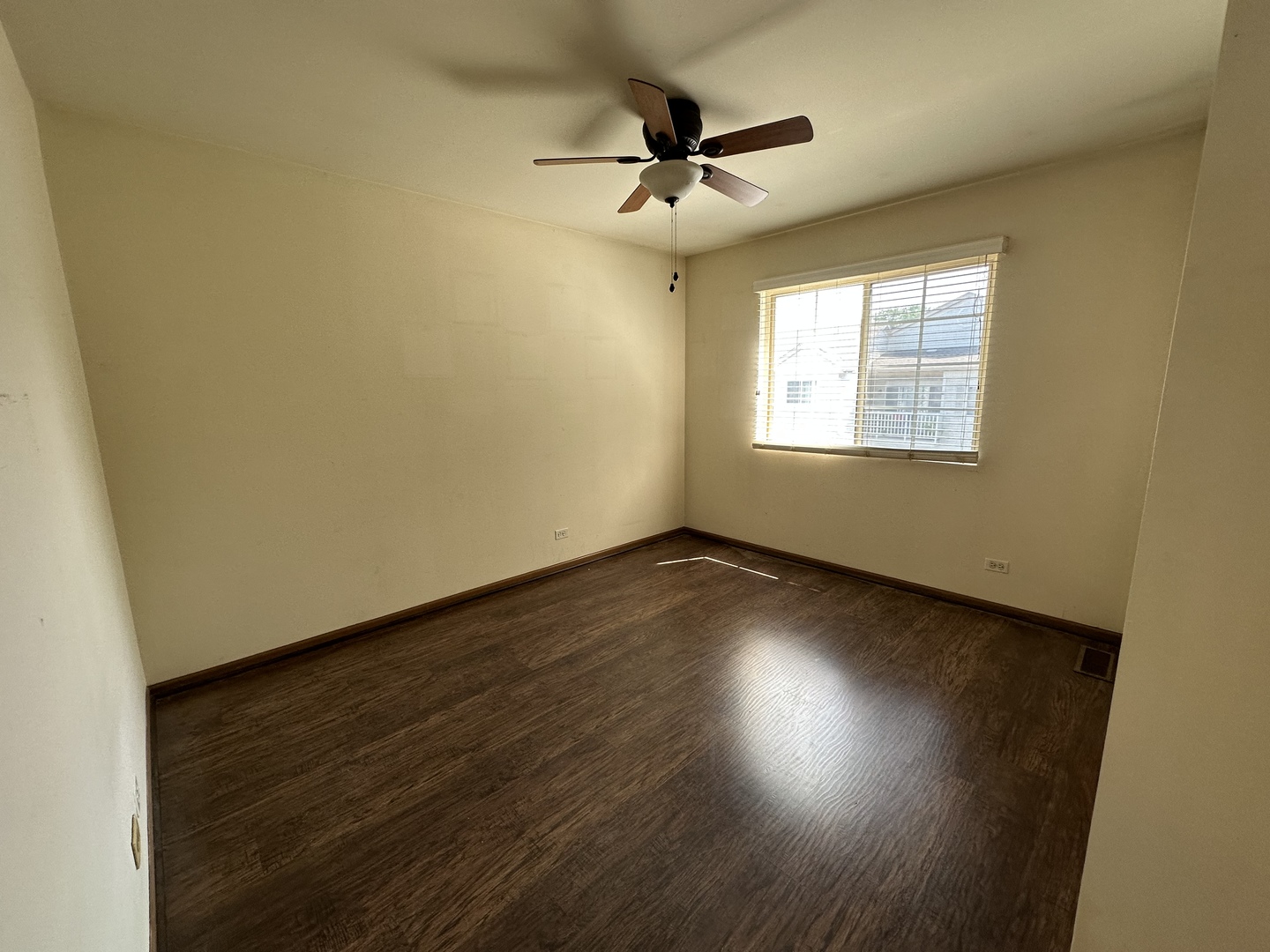 130 Creston Circle Aurora, IL 60504 - Photo 8 of 11 an empty room with wooden floor and windows