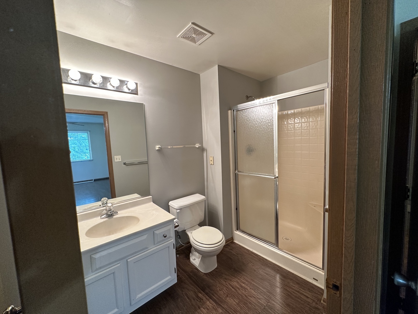 130 Creston Circle Aurora, IL 60504 - Photo 10 of 11 a bathroom with a toilet a sink and mirror