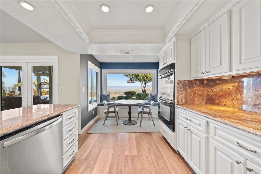6607 New Ridge Drive Riverside, CA 92506 - Photo 14 of 46 a kitchen with stainless steel appliances granite countertop a stove and a wooden floors