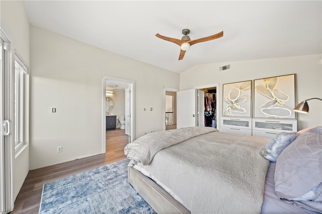 6607 New Ridge Drive Riverside, CA 92506 - Photo 16 of 46 a spacious bedroom with a large bed and a chandelier