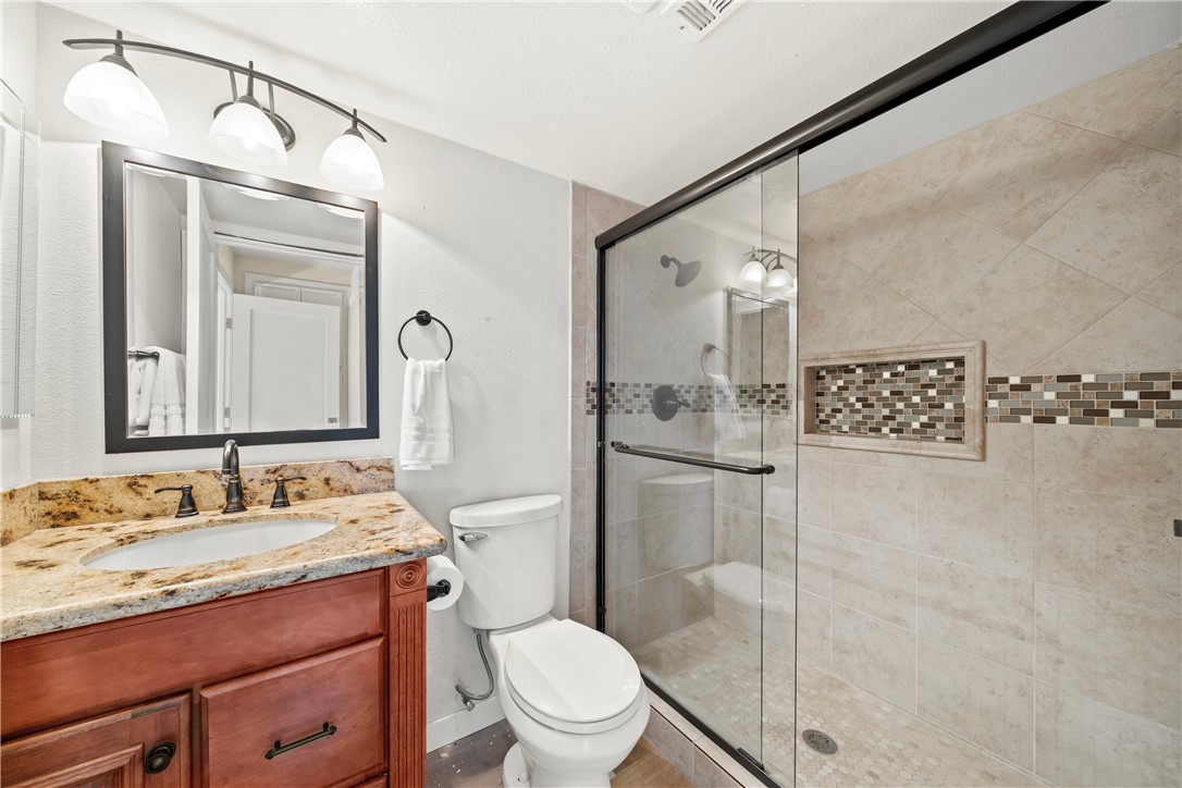 6607 New Ridge Drive Riverside, CA 92506 - Photo 45 of 46 a bathroom with a granite countertop sink toilet and shower
