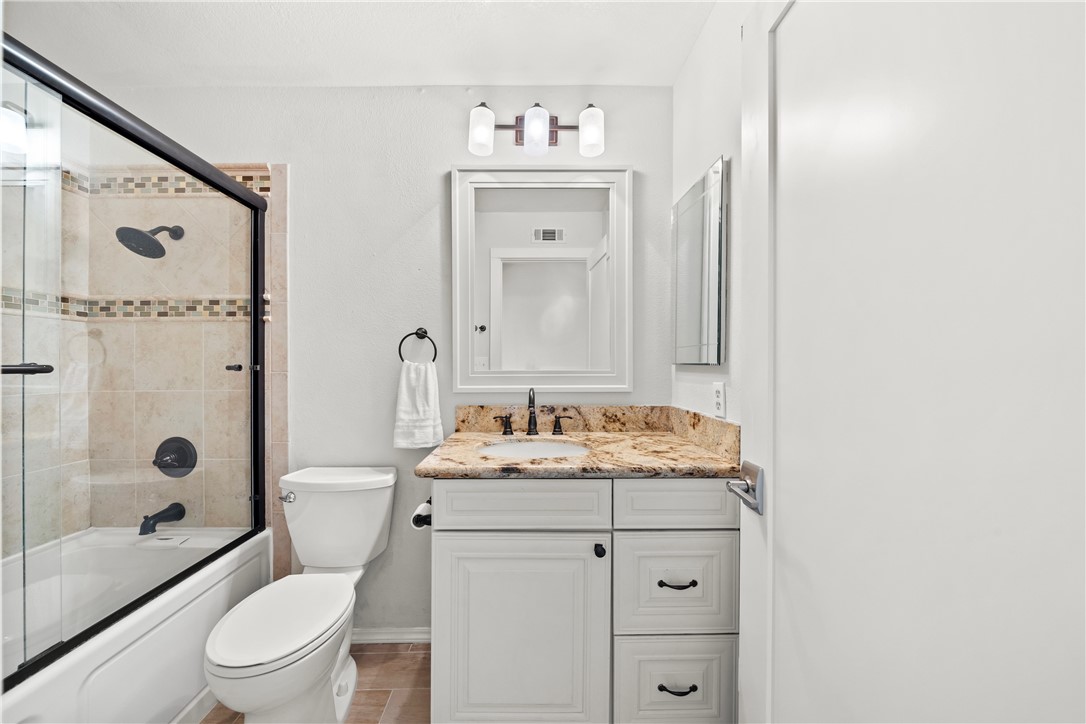 6607 New Ridge Drive Riverside, CA 92506 - Photo 46 of 46 a bathroom with a granite countertop sink a toilet and shower