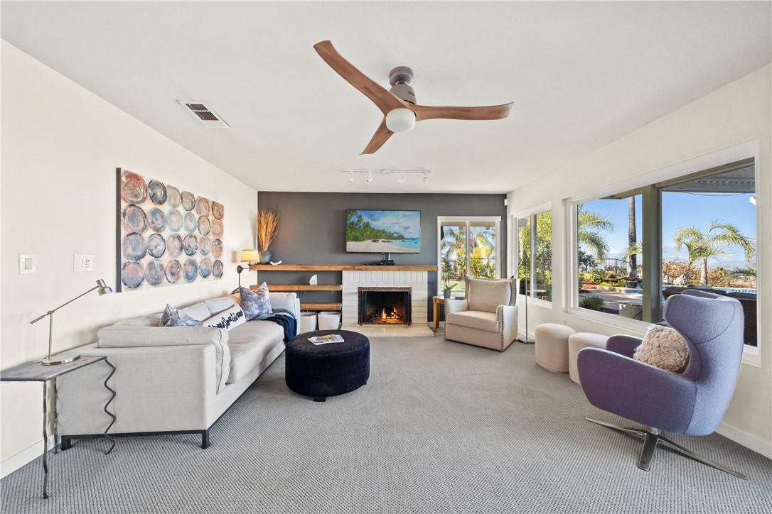 6607 New Ridge Drive Riverside, CA 92506 - Photo 6 of 46 a living room with furniture a fireplace and a large window
