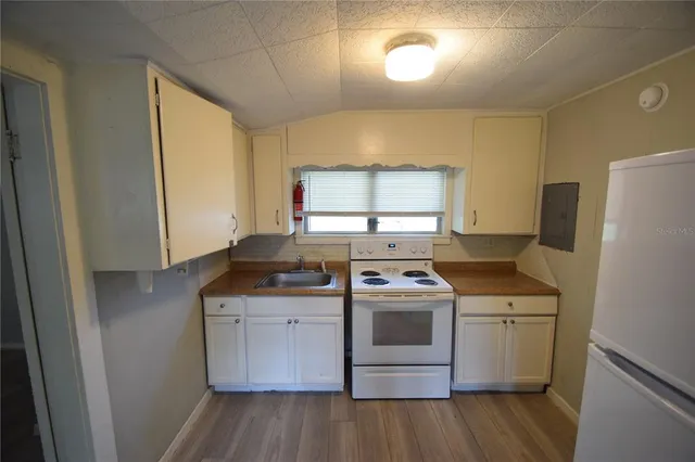 a view of kitchen with wooden floor washer and dryer