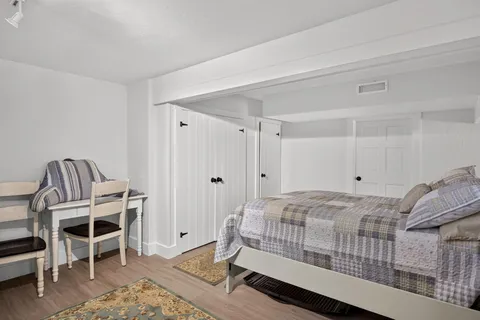 a bedroom with a bed and a chair