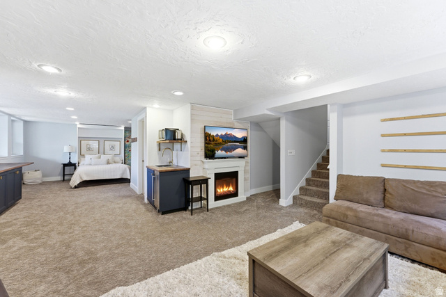 7935 Mustang Loop Road Park City, UT 84098 - Photo 32 of 60 Open-concept living space with plush carpeting, recessed lighting, and a built-in electric fireplace featuring a shiplap accent wall