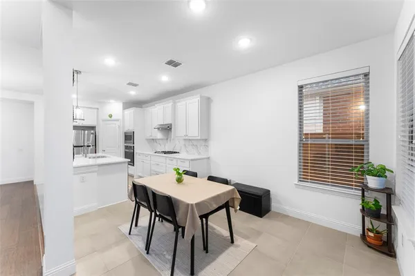 a kitchen with a table and chairs in it