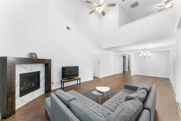 a living room with furniture a fireplace and a flat screen tv