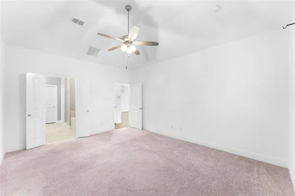 a view of an empty room with a fan