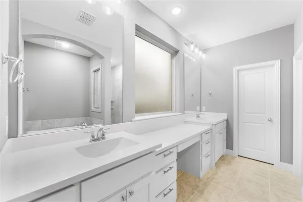 a bathroom with a sink double vanity and a mirror