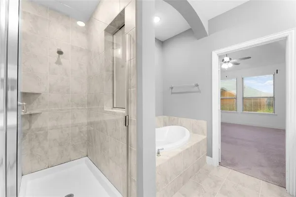 a bathroom with a tub and shower