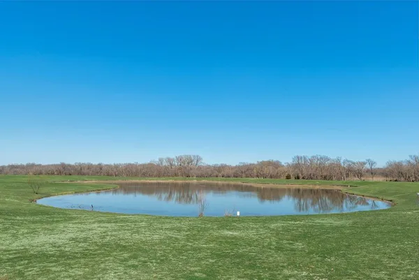 a view of a lake with houses in the background