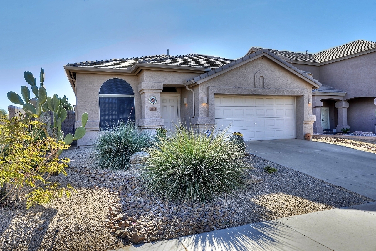 4243 East Tether Trail Phoenix, AZ 85050 - Photo 1 of 28 a front view of a house with garden