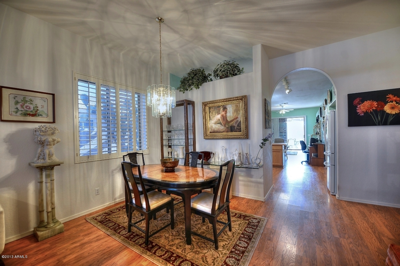 4243 East Tether Trail Phoenix, AZ 85050 - Photo 12 of 28 a view of a a dining room with furniture window and wooden floor