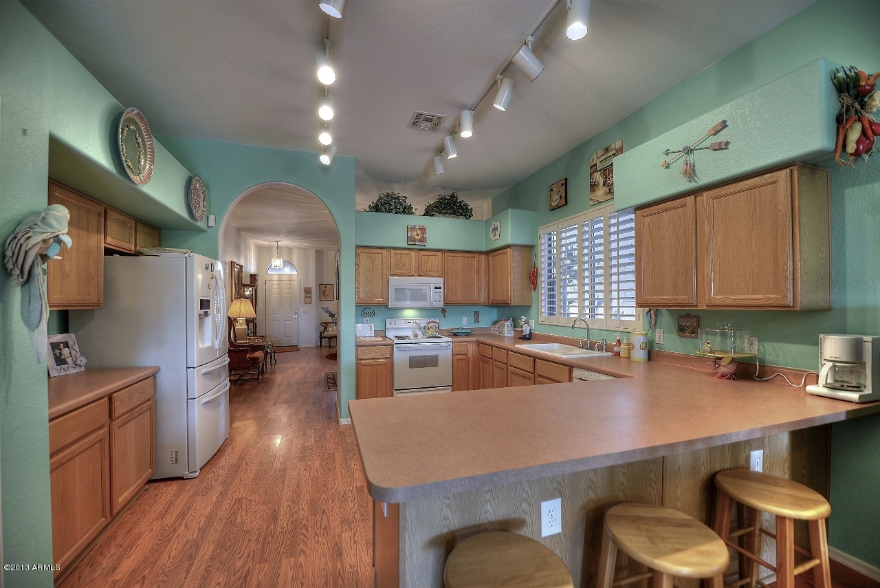 4243 East Tether Trail Phoenix, AZ 85050 - Photo 13 of 28 a kitchen with a table chairs sink and cabinets