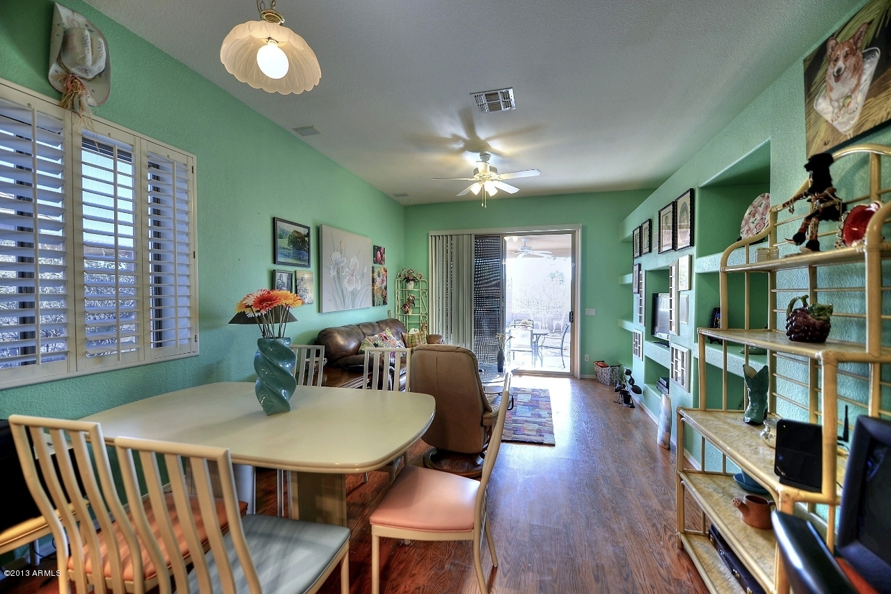 4243 East Tether Trail Phoenix, AZ 85050 - Photo 16 of 28 a view of a dining room with furniture and a book shelf
