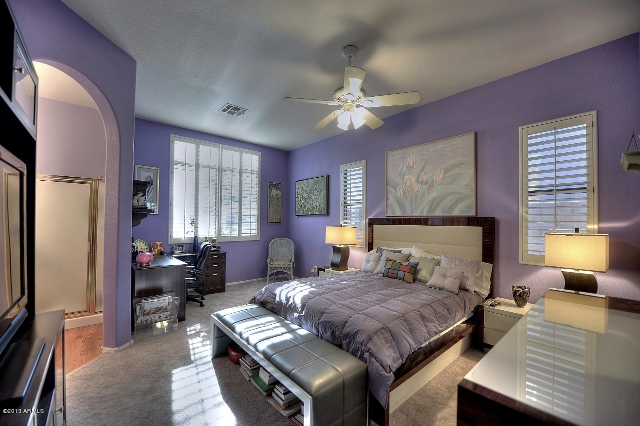 4243 East Tether Trail Phoenix, AZ 85050 - Photo 18 of 28 a bedroom with a large bed a chandelier and dresser