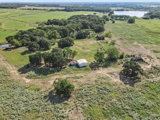 a view of a lake with beach and outdoor space