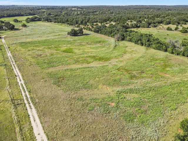 a view of a field with an ocean view