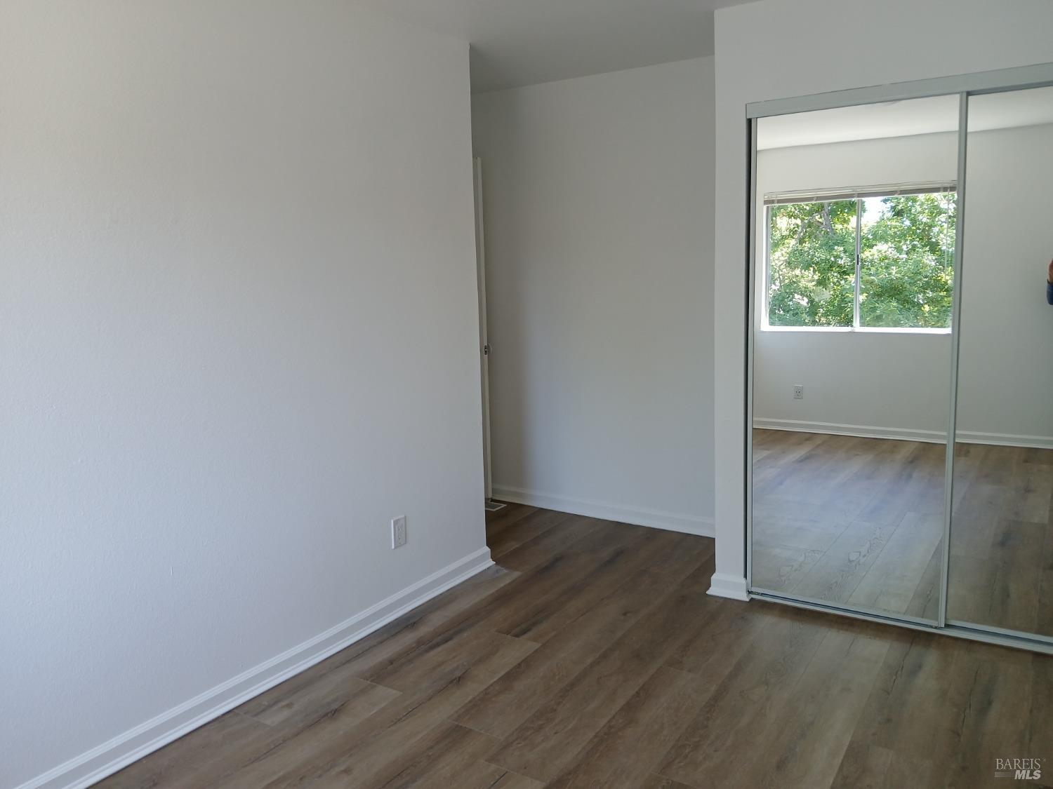 381 Wall Place Santa Rosa, CA 95401 - Photo 13 of 18 an empty room with wooden floor and windows