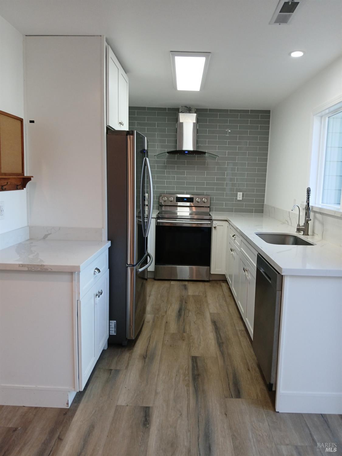 381 Wall Place Santa Rosa, CA 95401 - Photo 10 of 18 a kitchen with stainless steel appliances granite countertop a sink stove and refrigerator