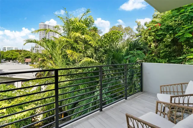 a balcony with next to a yard
