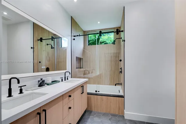 a bathroom with a double vanity sink and a bathtub