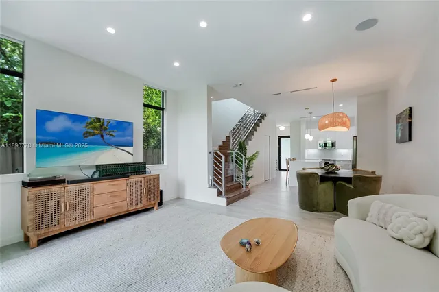 a living room with furniture and wooden floor