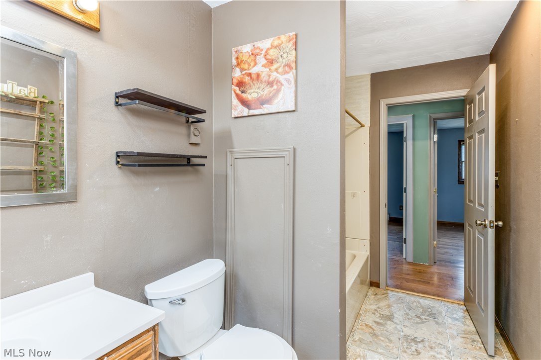 8750 Whitaker Road Cambridge, OH 43725 - Photo 18 of 29 Full bathroom with vanity, toilet, tile flooring, and shower / bathing tub combination