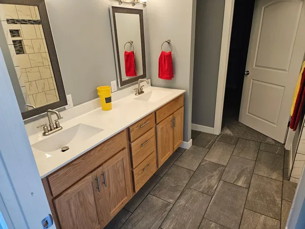 a bathroom with a sink vanity and a mirror