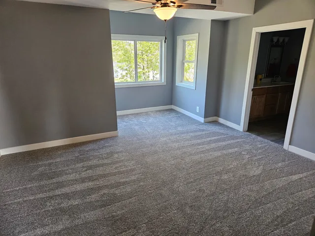 an empty room with windows and closet