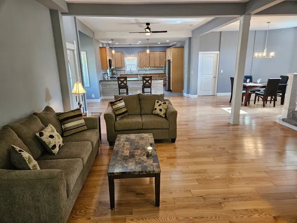 a living room with furniture and a chandelier