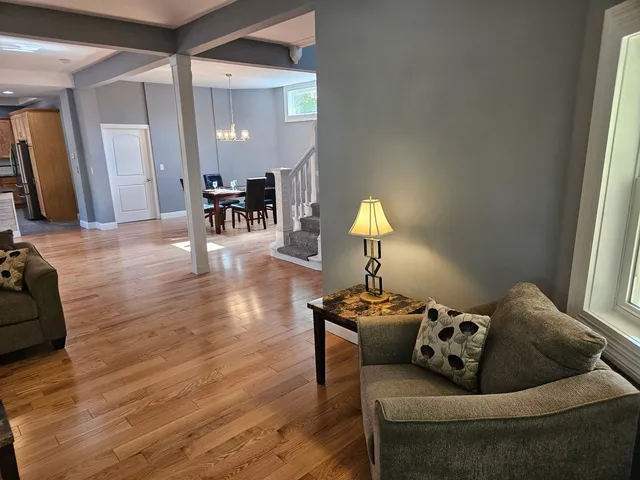 a living room with furniture and a wooden floor