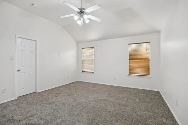 a living room with stainless steel appliances wooden floor and a large window