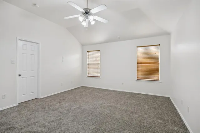 a living room with stainless steel appliances wooden floor and a large window