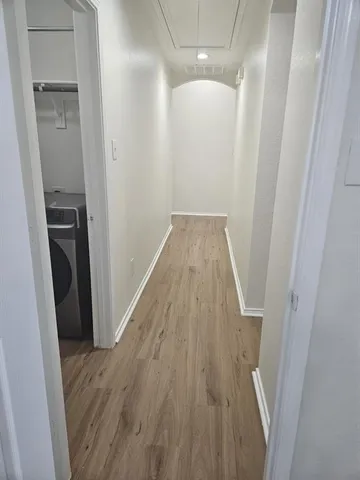 an empty room with windows and ceiling fan