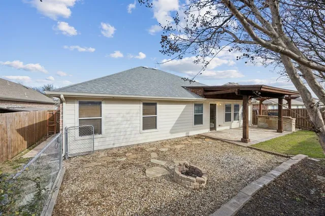 a view of a backyard with wooden fence