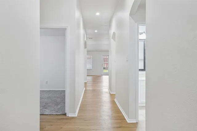 a view of a hallway with wooden floor