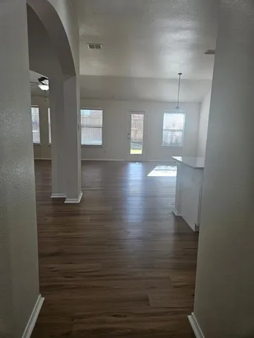 a view of a room with wooden floor
