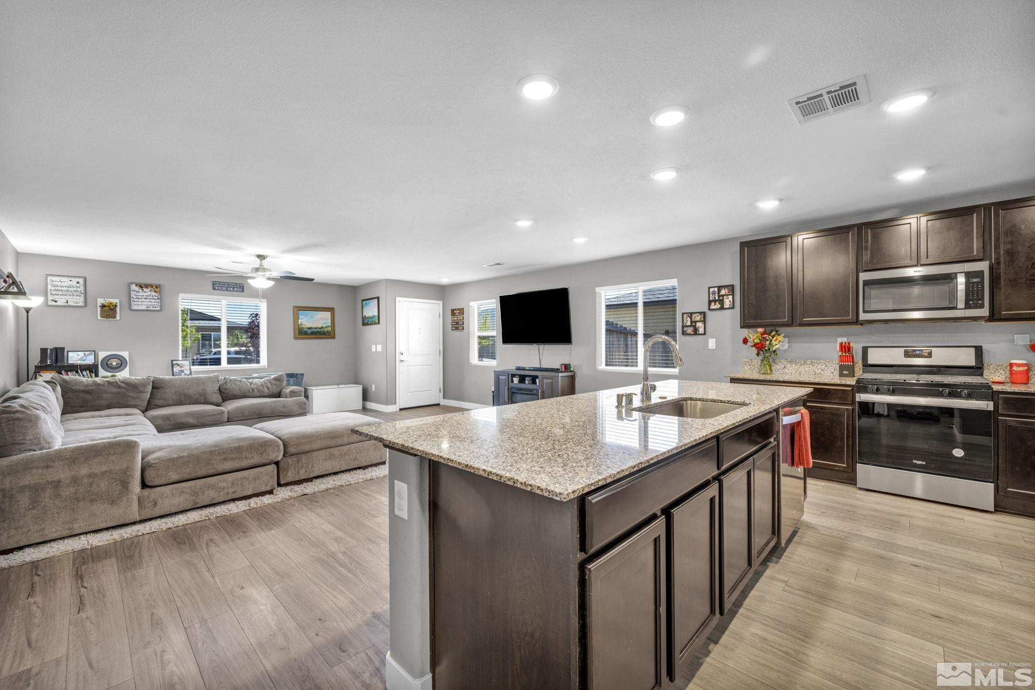 623 Yerington Drive Reno, NV 89506 - Photo 3 of 40 a large kitchen with stainless steel appliances kitchen island granite countertop a large center island and a sink