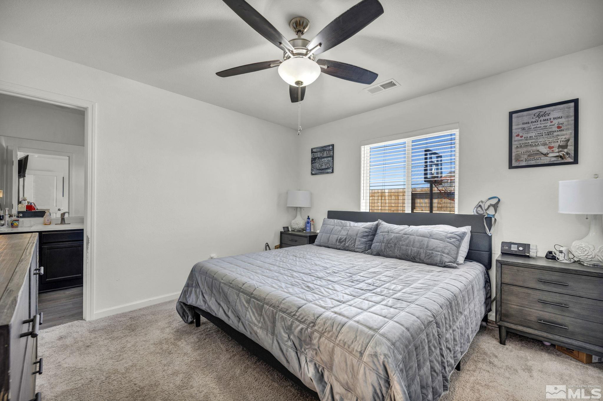 623 Yerington Drive Reno, NV 89506 - Photo 31 of 40 a bedroom with a bed and a chandelier