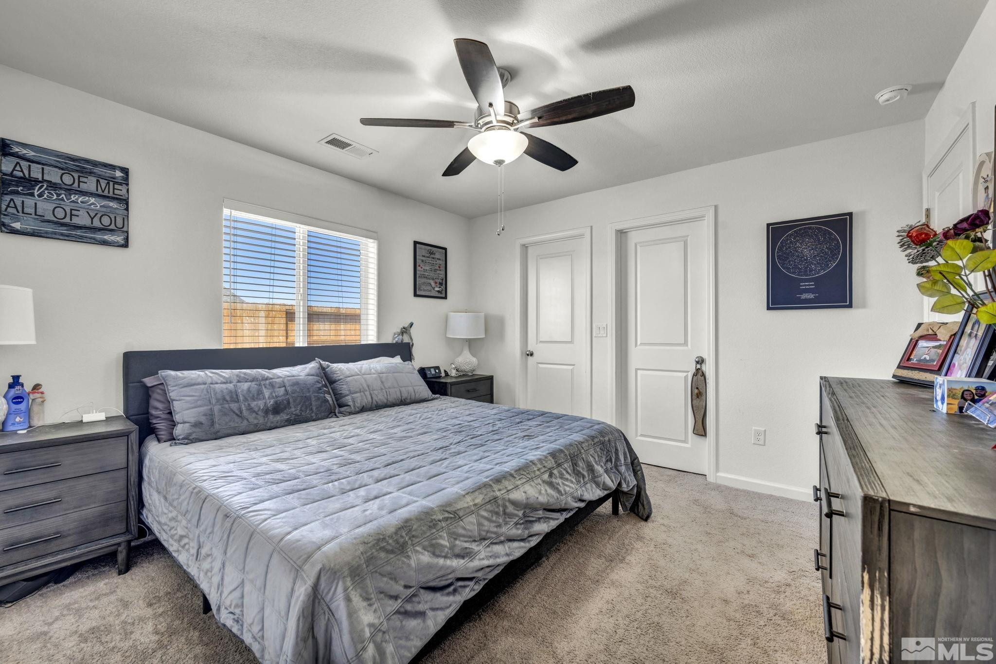 623 Yerington Drive Reno, NV 89506 - Photo 32 of 40 a bedroom with a bed and a chandelier