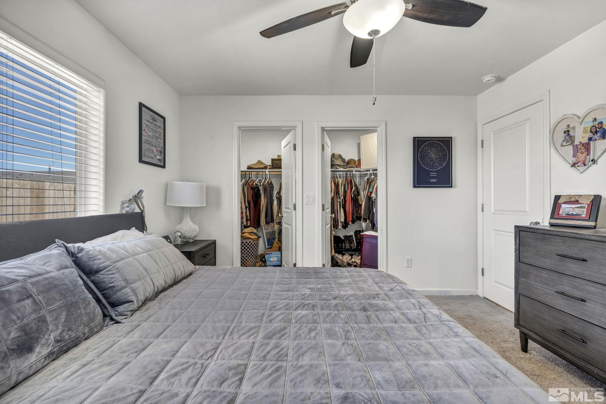 623 Yerington Drive Reno, NV 89506 - Photo 33 of 40 a bedroom with a bed and a chandelier